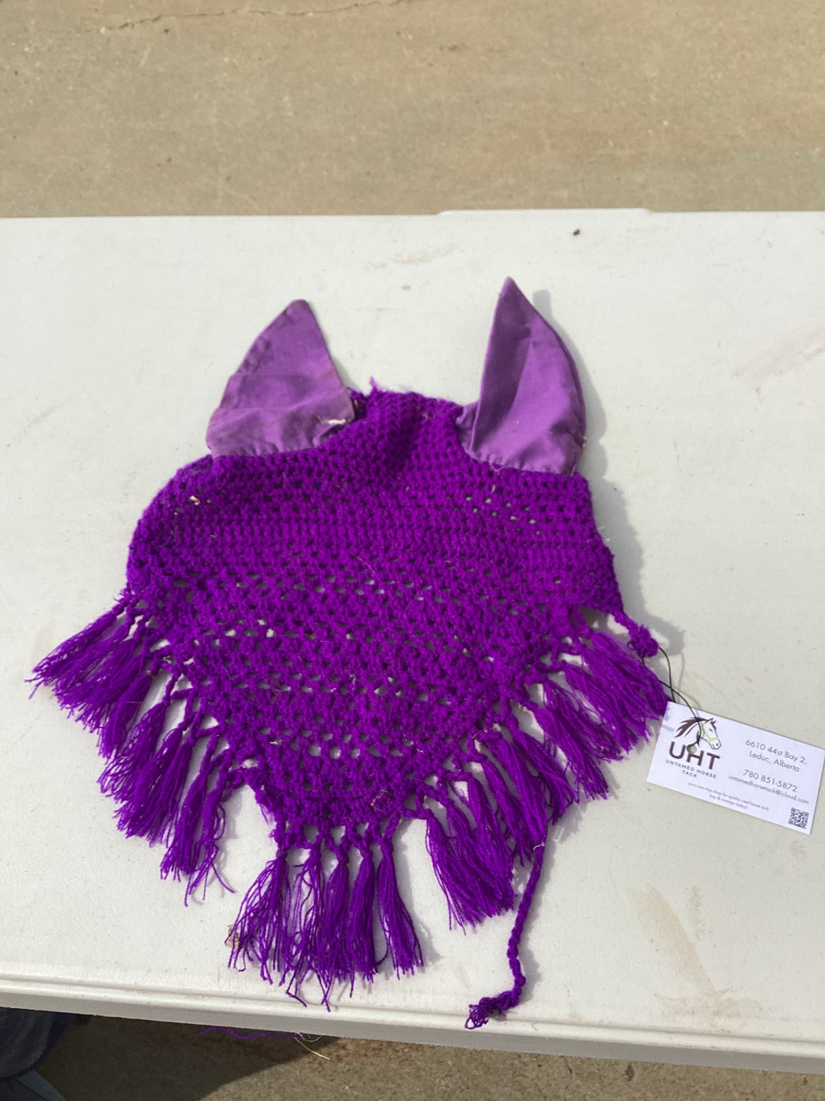 horse fly bonnet with decorative tassle on the bottom 
