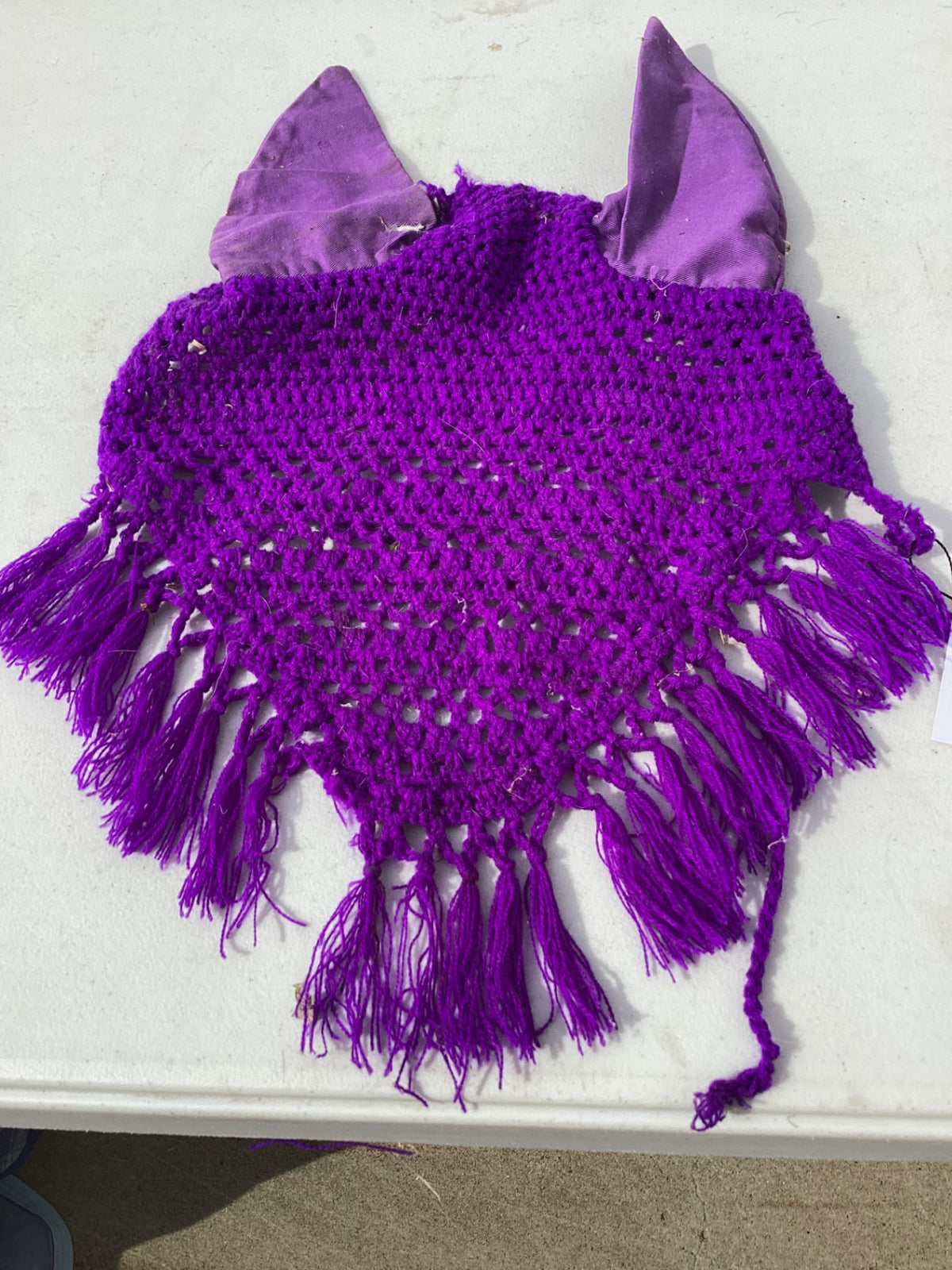 horse fly bonnet with decorative tassle on the bottom 