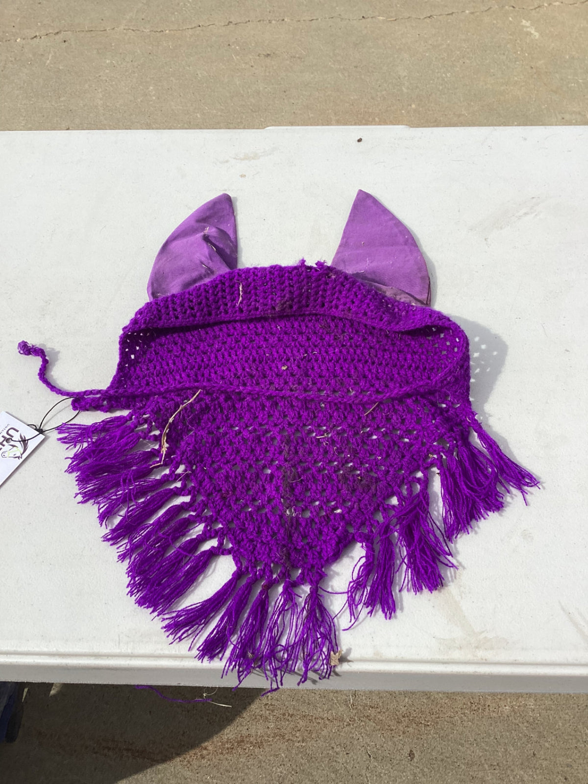 horse fly bonnet with decorative tassle on the bottom 